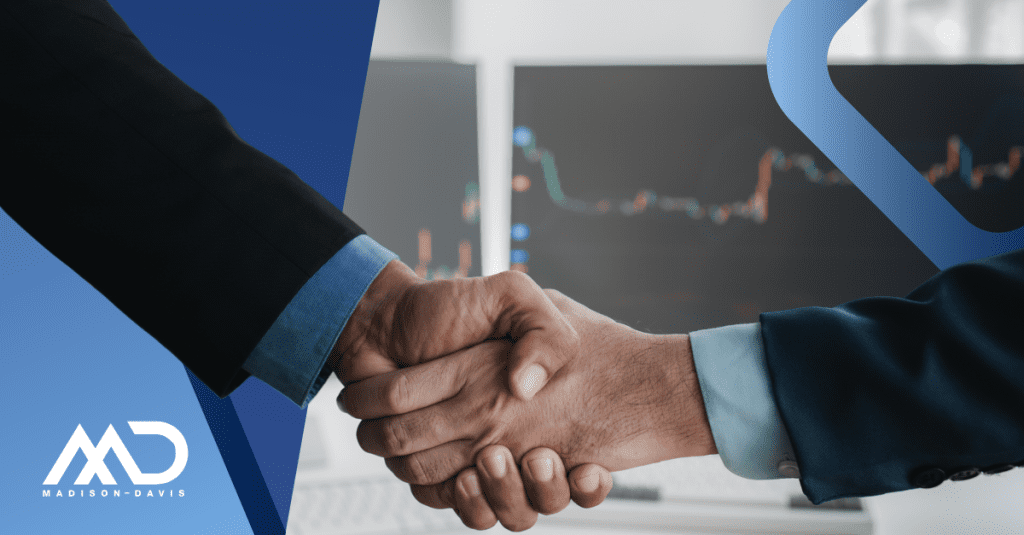 A fintech startup successfully closes a negotiation with a compliance officer, seen through a handshake.