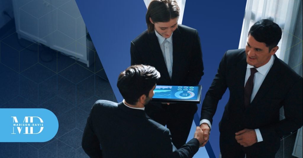 Three fintech professionals stand in a circle